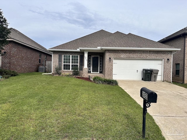 2450 Redford Dr, Cantonment, FL 32533 - view of front facade featuring brick siding, concrete driveway, a garage, central AC, and a front yard