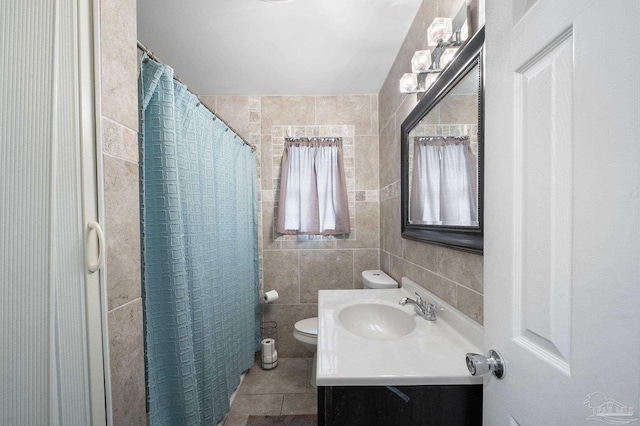 bathroom featuring tile walls, tile patterned flooring, vanity, toilet, and a shower with shower curtain