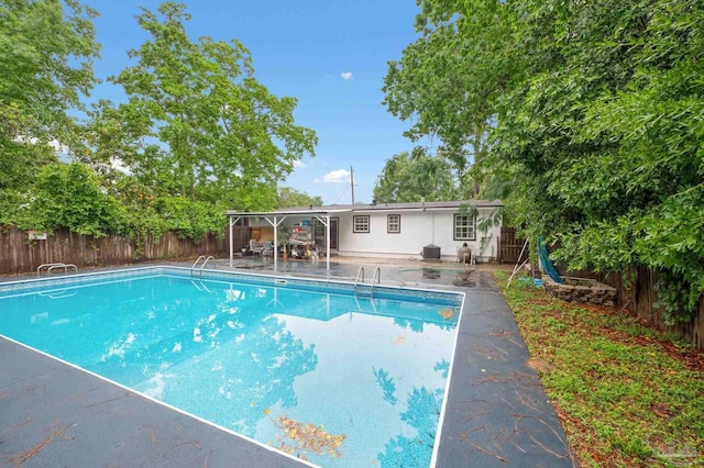 view of pool featuring cooling unit and a patio area