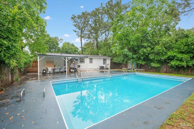 view of swimming pool with a patio area