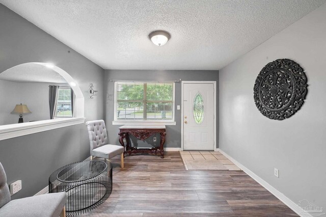 entryway with hardwood / wood-style flooring and a textured ceiling