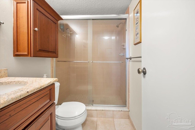 bathroom featuring toilet, walk in shower, tile patterned flooring, vanity, and a textured ceiling