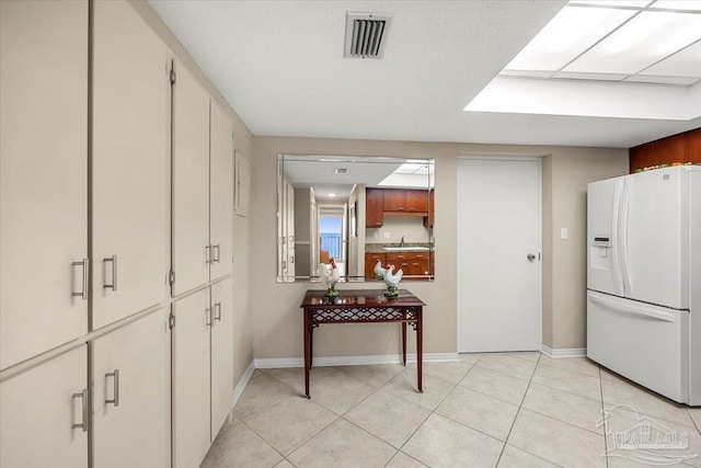 interior space with sink and light tile patterned flooring