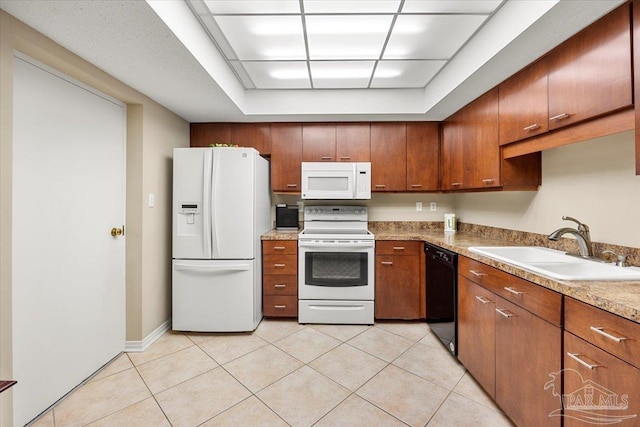 kitchen featuring white appliances, light tile patterned floors, and sink