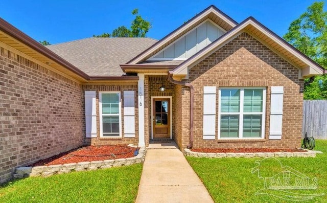 1516 Cadence Loop, Cantonment, FL 32533 - doorway to property featuring brick siding and board and batten siding