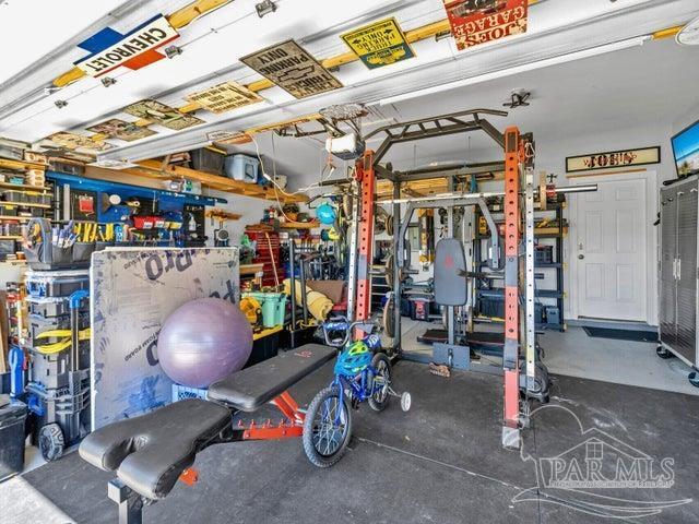 1516 Cadence Loop, Cantonment, FL 32533 - exercise room featuring a workshop area