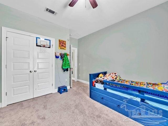 1516 Cadence Loop, Cantonment, FL 32533 - unfurnished bedroom featuring carpet floors, baseboards, a ceiling fan, and a closet
