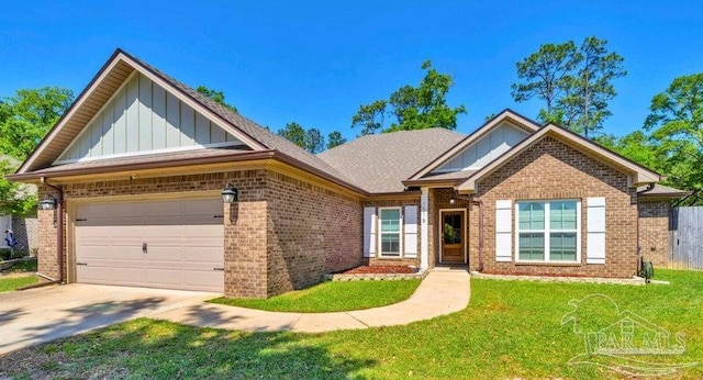 1516 Cadence Loop, Cantonment, FL 32533 - view of front of house with board and batten siding, brick siding, a front lawn, and concrete driveway