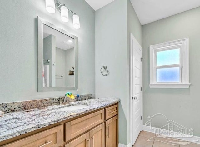 1516 Cadence Loop, Cantonment, FL 32533 - bathroom with vanity, tile patterned floors, and baseboards