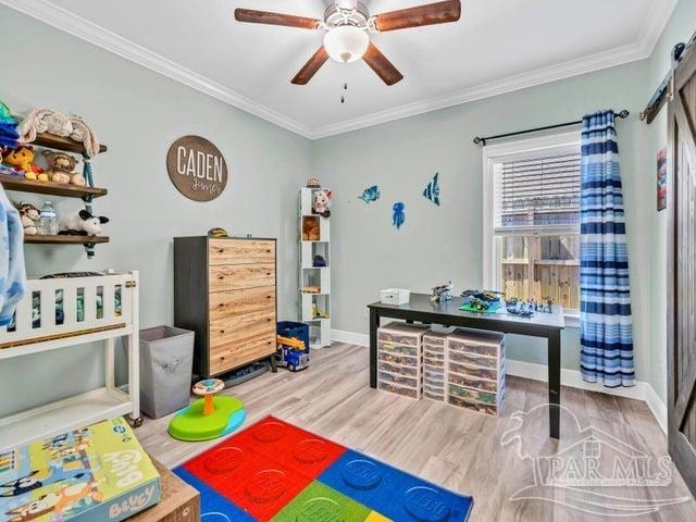 1516 Cadence Loop, Cantonment, FL 32533 - game room with ceiling fan, crown molding, wood finished floors, and baseboards