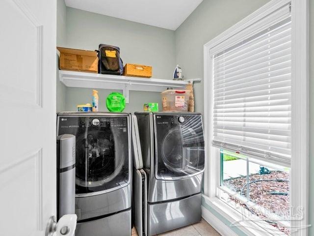 1516 Cadence Loop, Cantonment, FL 32533 - washroom featuring washer and clothes dryer and tile patterned floors