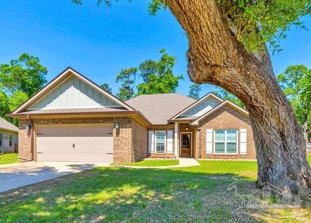 1516 Cadence Loop, Cantonment, FL 32533 - view of front of house with brick siding, board and batten siding, a garage, a front lawn, and concrete driveway