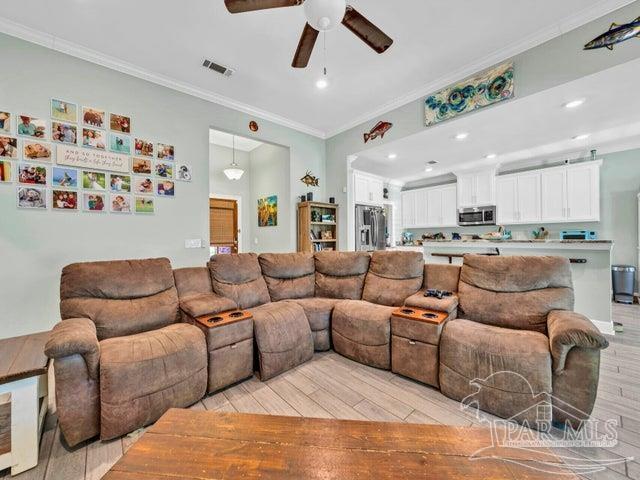 1516 Cadence Loop, Cantonment, FL 32533 - living area with light wood-type flooring, ceiling fan, ornamental molding, and recessed lighting