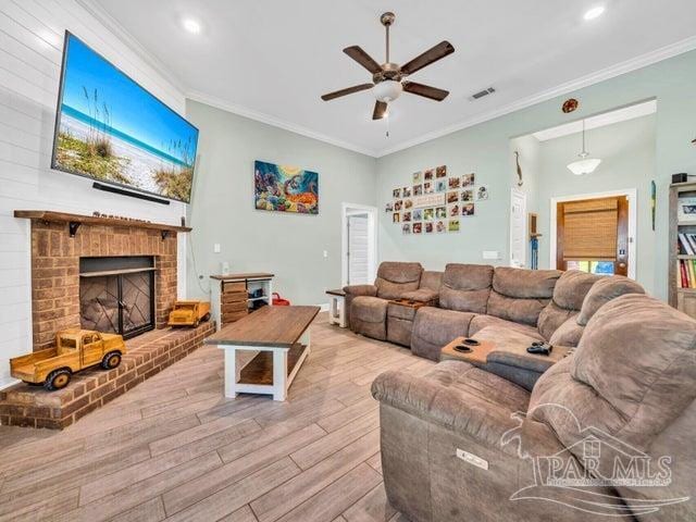 1516 Cadence Loop, Cantonment, FL 32533 - living room featuring wood finished floors, a ceiling fan, ornamental molding, a brick fireplace, and recessed lighting