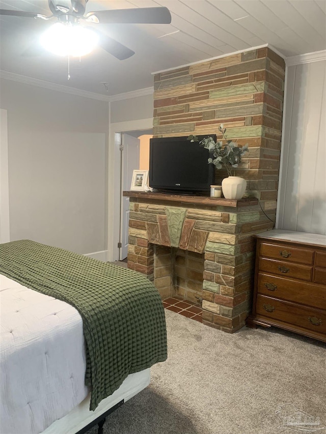 carpeted bedroom with ceiling fan, a fireplace, and ornamental molding