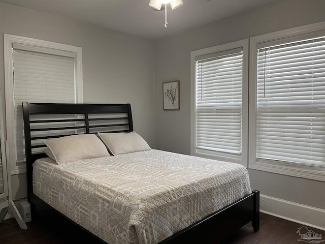 bedroom featuring ceiling fan and dark wood-type flooring