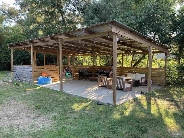 exterior space featuring a lawn, outdoor lounge area, and a patio