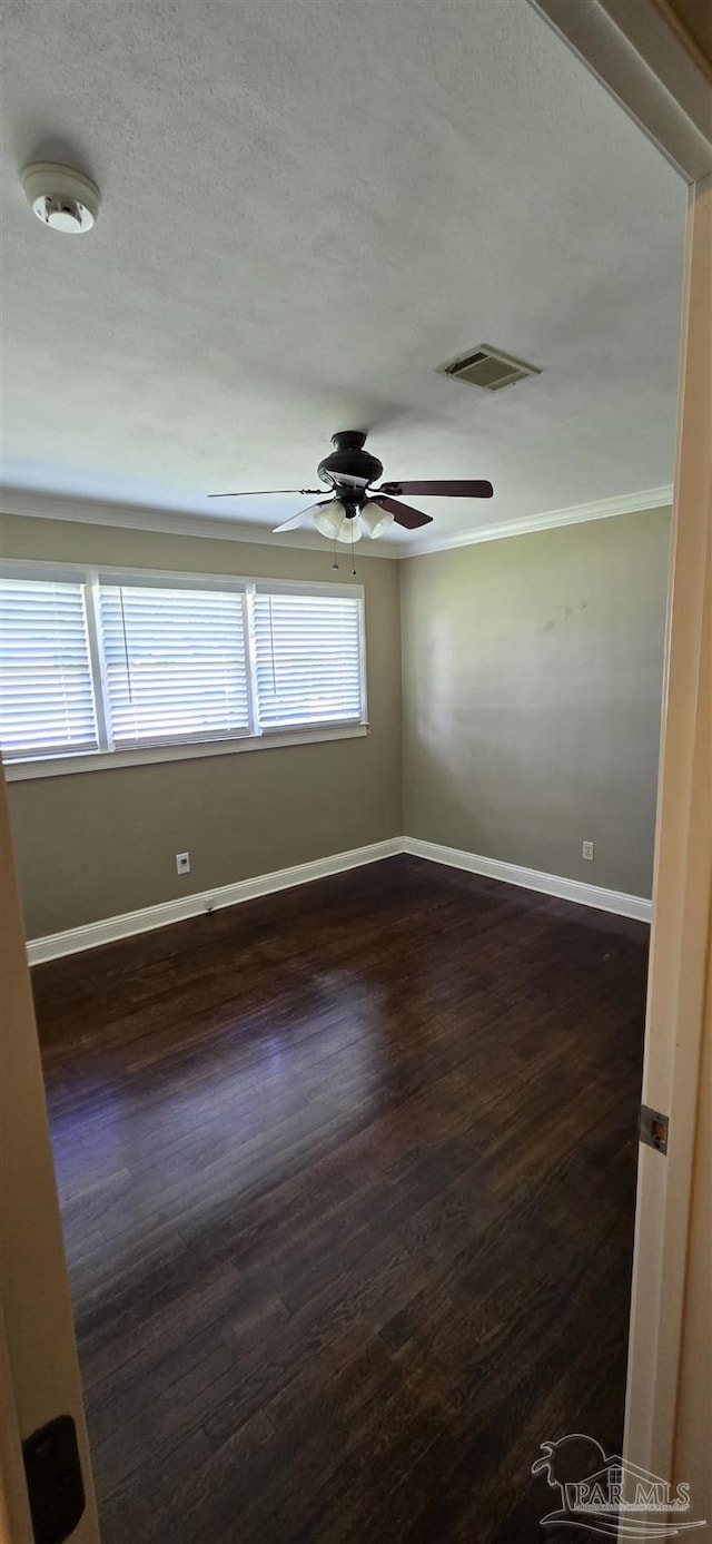 381 Euclid St, Pensacola, FL 32503 - empty room with a ceiling fan, dark wood finished floors, crown molding, and a textured ceiling