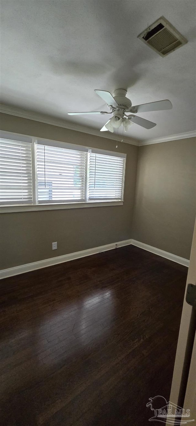 381 Euclid St, Pensacola, FL 32503 - unfurnished room featuring ornamental molding, dark wood-style floors, and ceiling fan