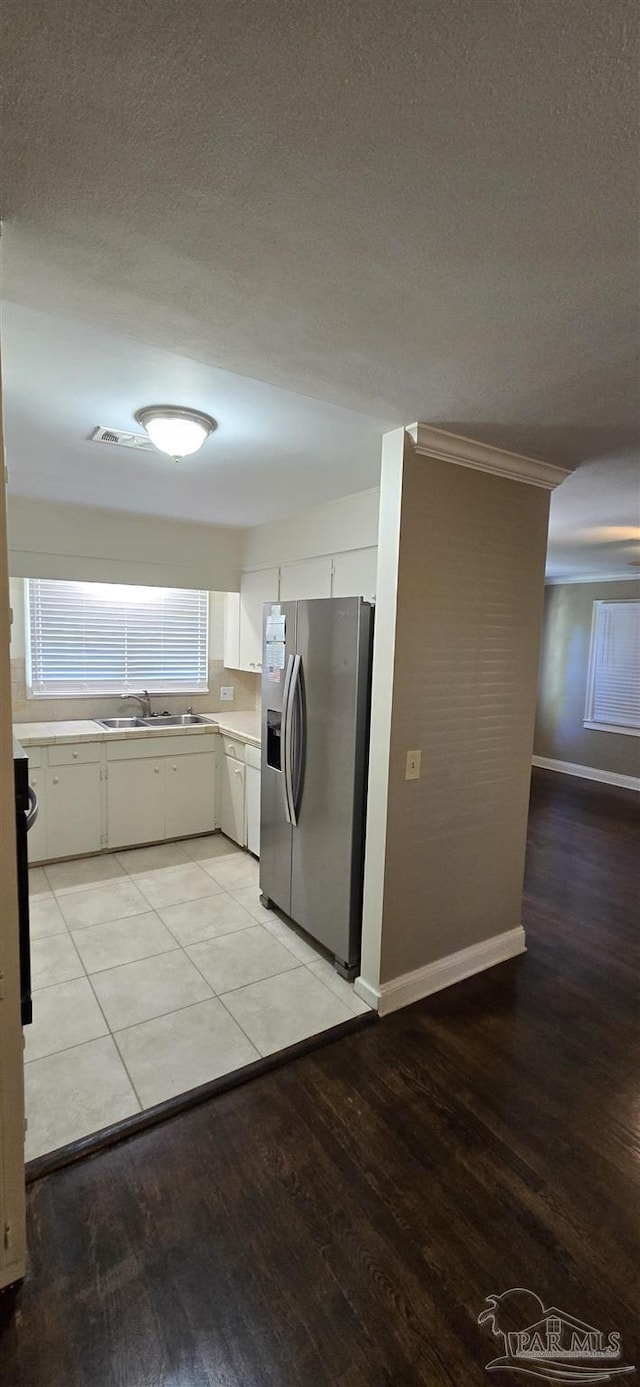 381 Euclid St, Pensacola, FL 32503 - laundry area with light wood-style floors, ornamental molding, and a textured ceiling