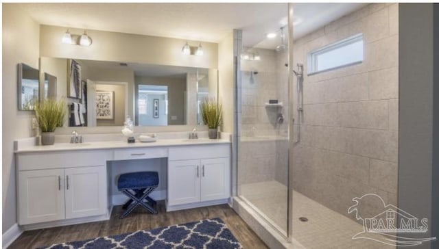 5752 Farrel Way, Milton, FL 32583 - bathroom featuring wood finished floors, a tile shower, and double vanity