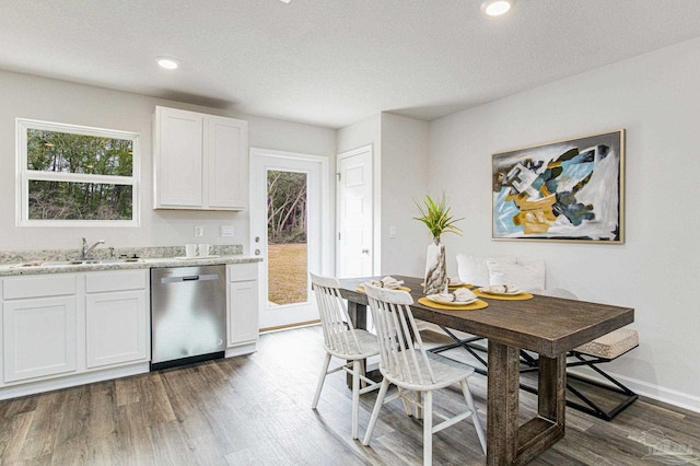 kitchen featuring sink, stainless steel dishwasher, white cabinets, and dark hardwood / wood-style flooring