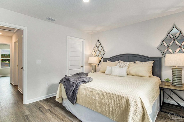 bedroom with dark hardwood / wood-style flooring