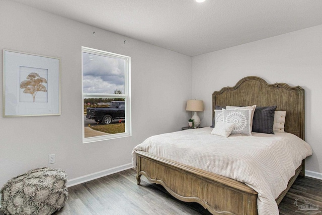 bedroom with dark hardwood / wood-style floors