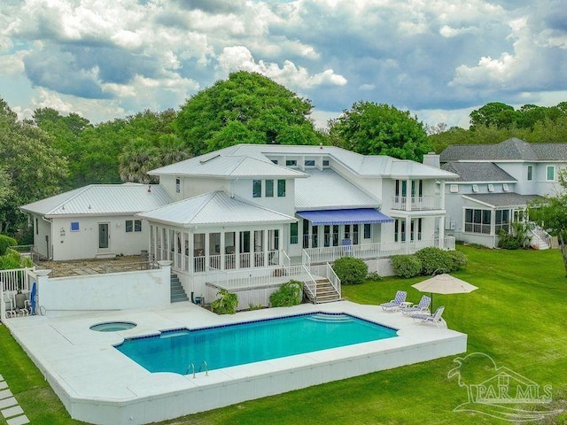 458 Parish Blvd, Mary Esther, FL 32569 - rear view of property with an in-ground hot tub, a sunroom, stairway, a yard, and an outdoor pool