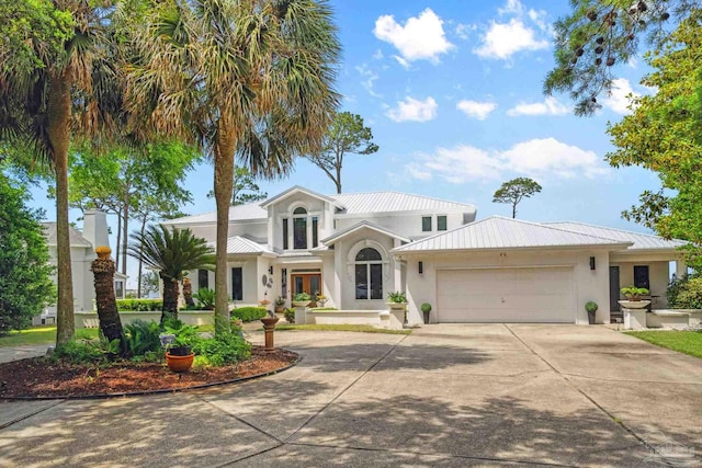 458 Parish Blvd, Mary Esther, FL 32569 - view of front of home featuring stucco siding, concrete driveway, a garage, and metal roof