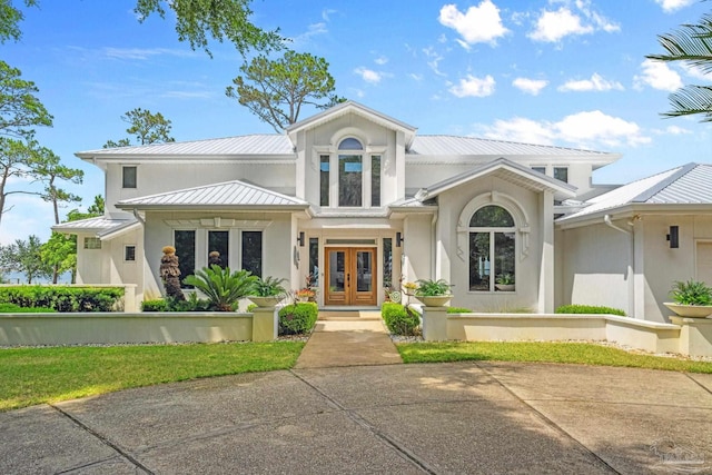458 Parish Blvd, Mary Esther, FL 32569 - view of front of house featuring french doors, metal roof, stucco siding, and a standing seam roof