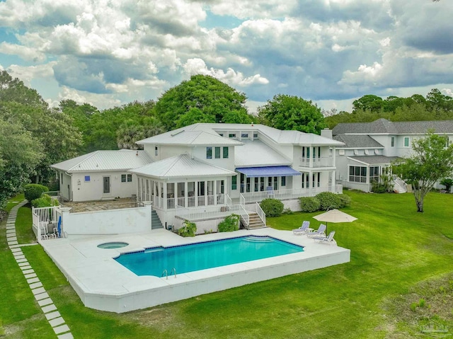 458 Parish Blvd, Mary Esther, FL 32569 - back of house with a sunroom, stairway, an in-ground hot tub, a yard, and an outdoor pool