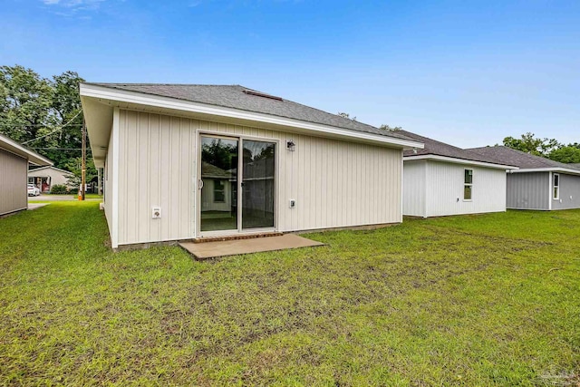 rear view of house with a yard