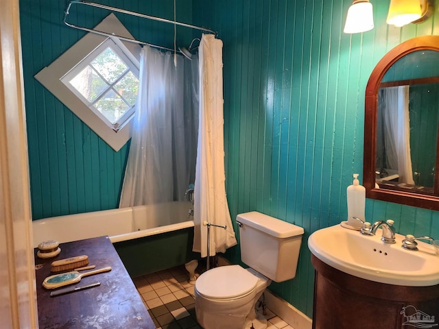 full bathroom featuring tile patterned floors, toilet, vanity, wooden walls, and shower / bath combo