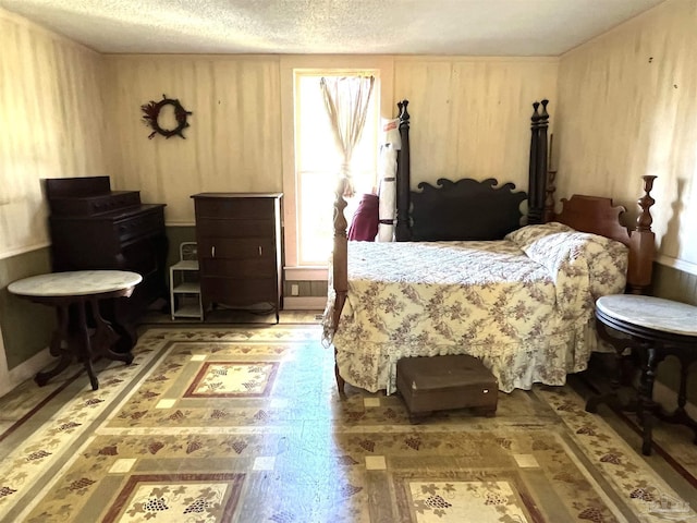 bedroom featuring wooden walls and a textured ceiling