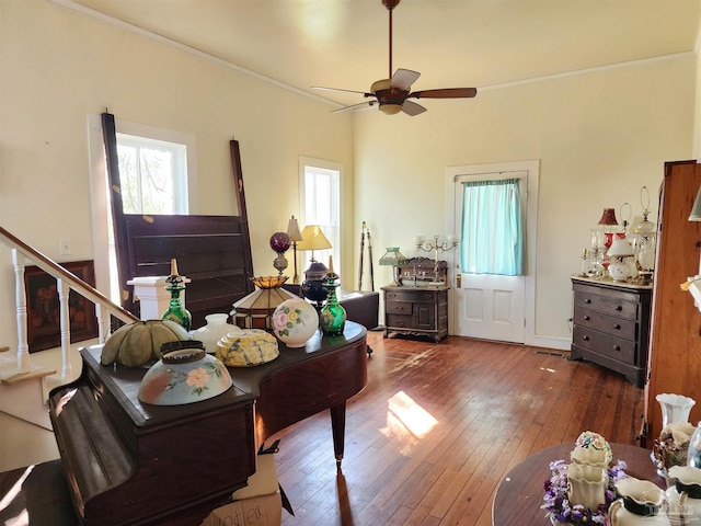 interior space featuring crown molding, a wealth of natural light, wood-type flooring, and ceiling fan