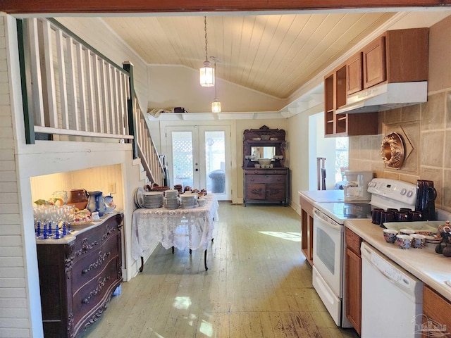 kitchen with french doors, vaulted ceiling, hanging light fixtures, light wood-type flooring, and white appliances