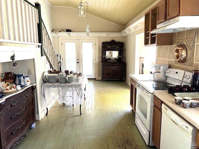 kitchen featuring vaulted ceiling, hanging light fixtures, dark wood-type flooring, white appliances, and french doors