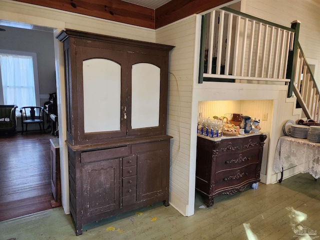 foyer entrance featuring hardwood / wood-style floors and wood walls