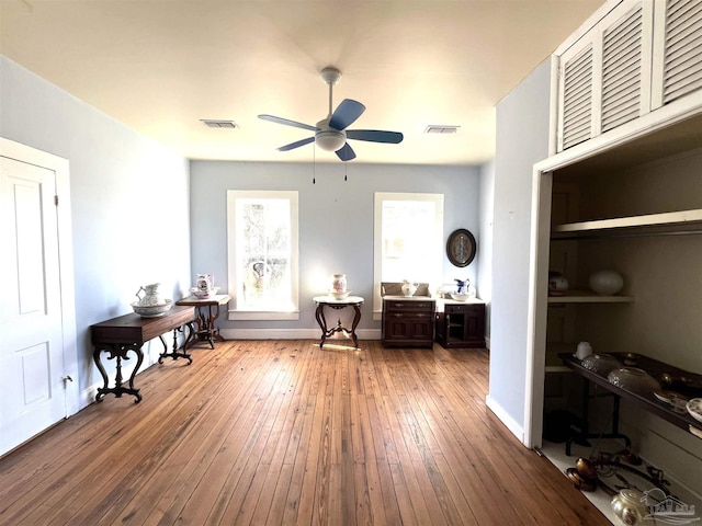 interior space with wood-type flooring and ceiling fan