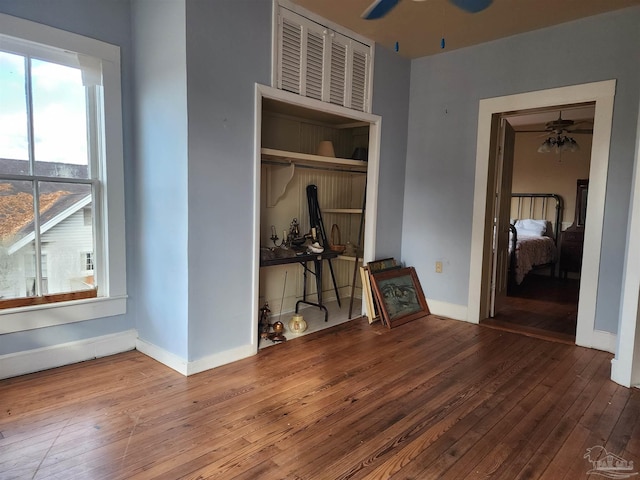 unfurnished room featuring hardwood / wood-style floors and ceiling fan