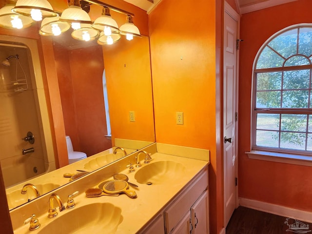 full bathroom with bathtub / shower combination, vanity, toilet, and wood-type flooring