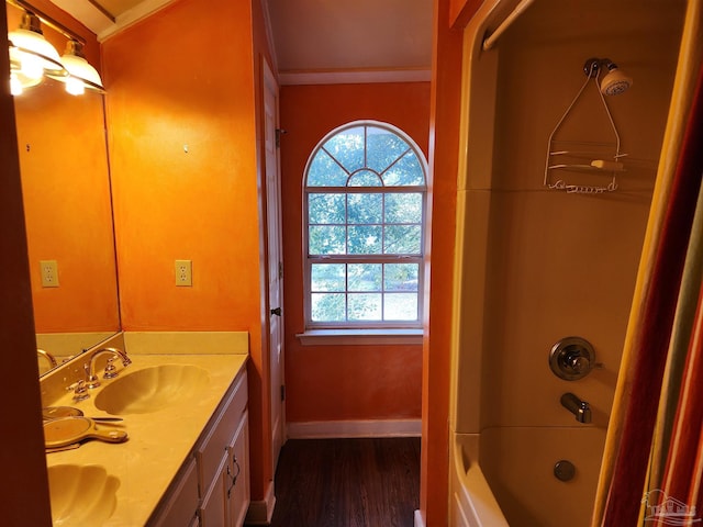 bathroom with vanity, hardwood / wood-style floors, and  shower combination