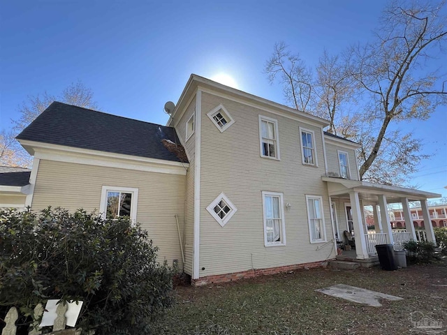 rear view of property featuring a porch