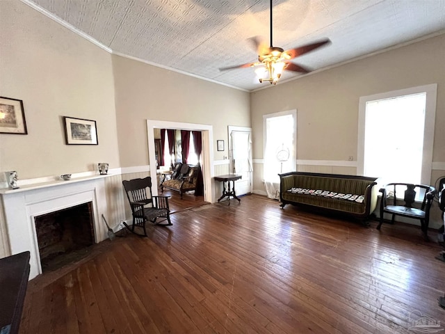 interior space with dark hardwood / wood-style flooring, ornamental molding, and ceiling fan