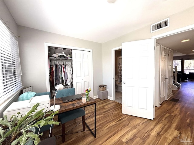 home office with baseboards, wood finished floors, and visible vents