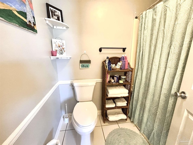 bathroom featuring toilet, a shower with curtain, and tile patterned flooring