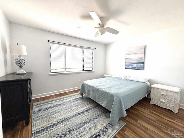 bedroom featuring baseboards, a ceiling fan, and wood finished floors