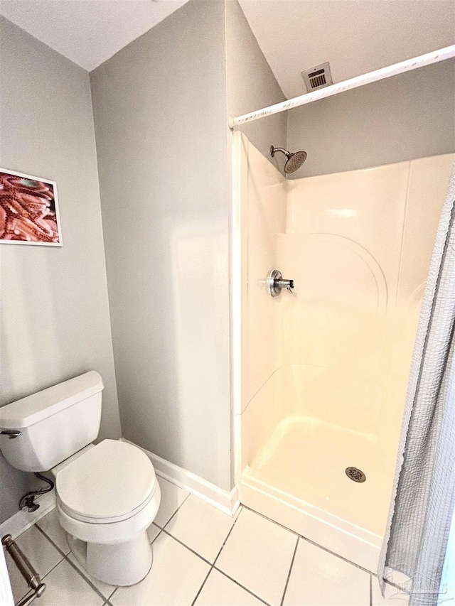 full bathroom with visible vents, a stall shower, tile patterned floors, baseboards, and toilet