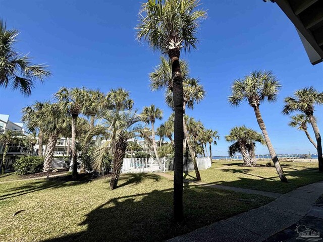 view of yard with fence and a water view